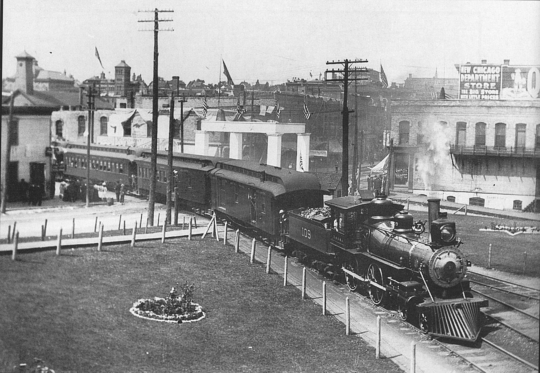 DSS&A 108 pulls passenger train in downtown Marquette